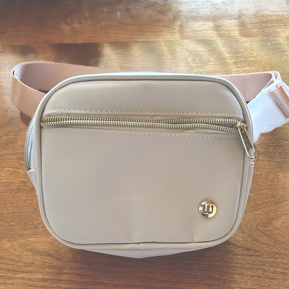 NWOT: Never used Fanny pack, White with pink strap, has an W lower left corner.
